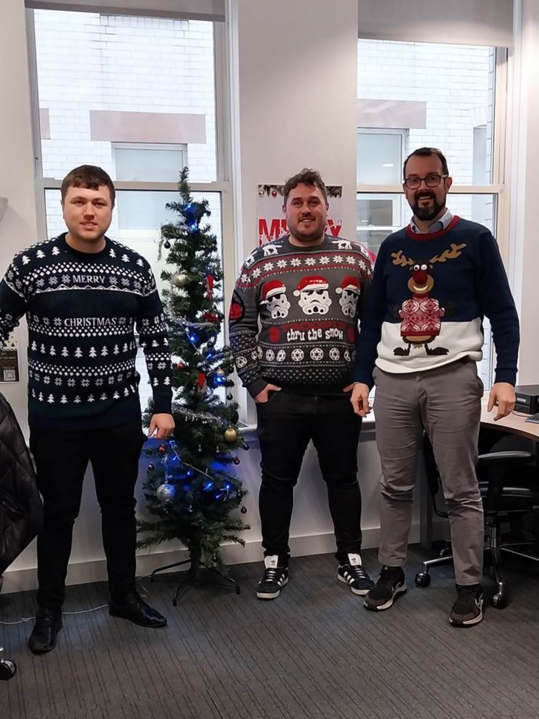 3 guys with Christmas jumpers on