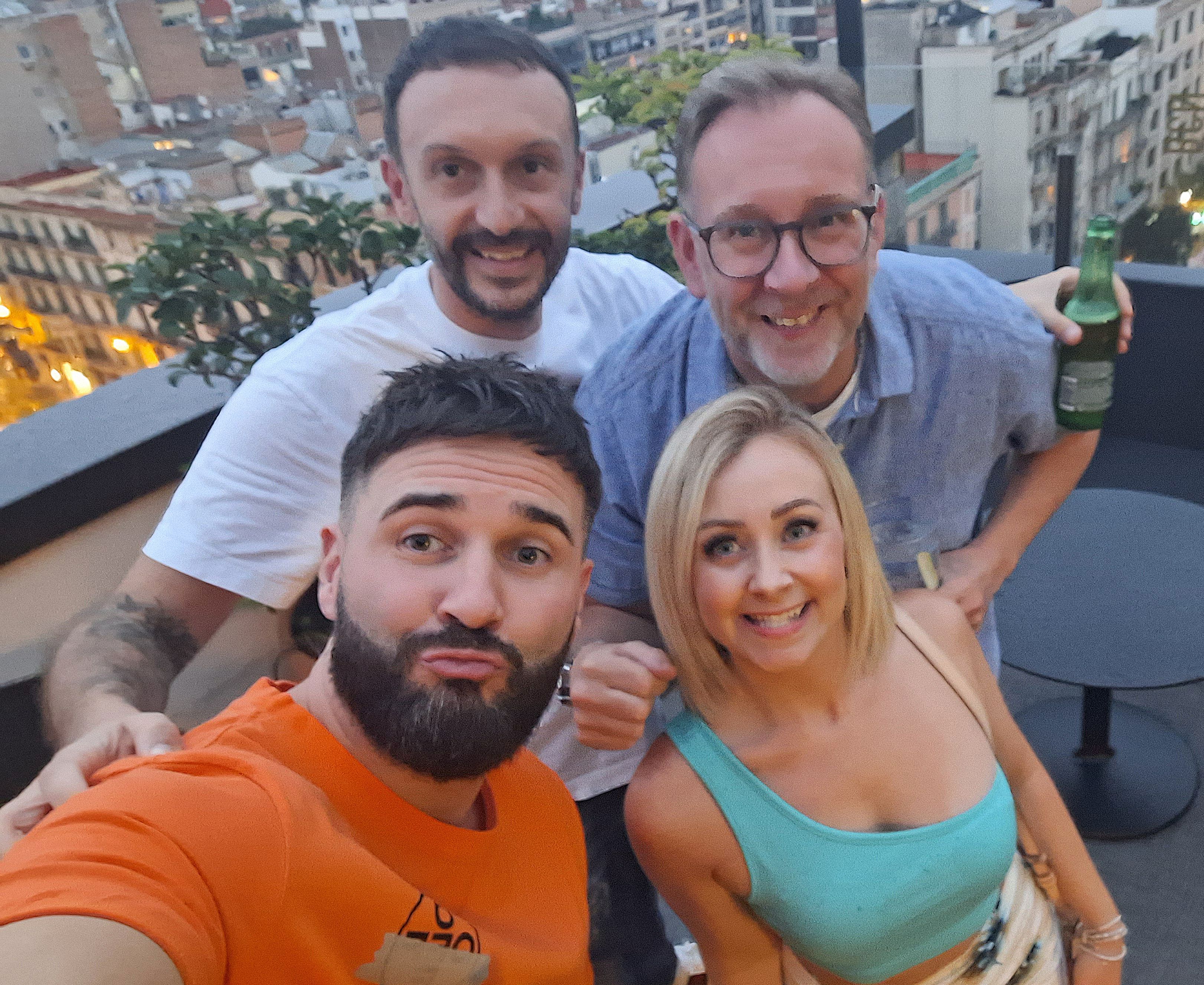 Adults taking a selfie on a balcony