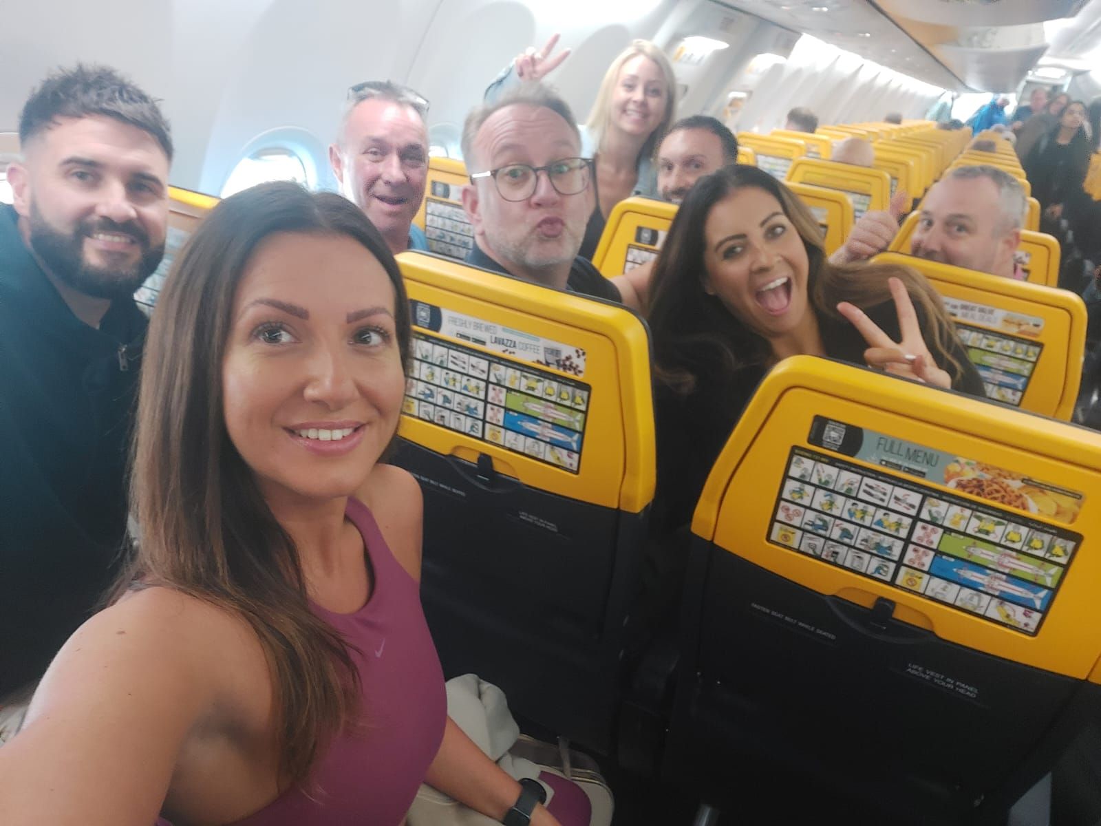 Team selfie on a plane.