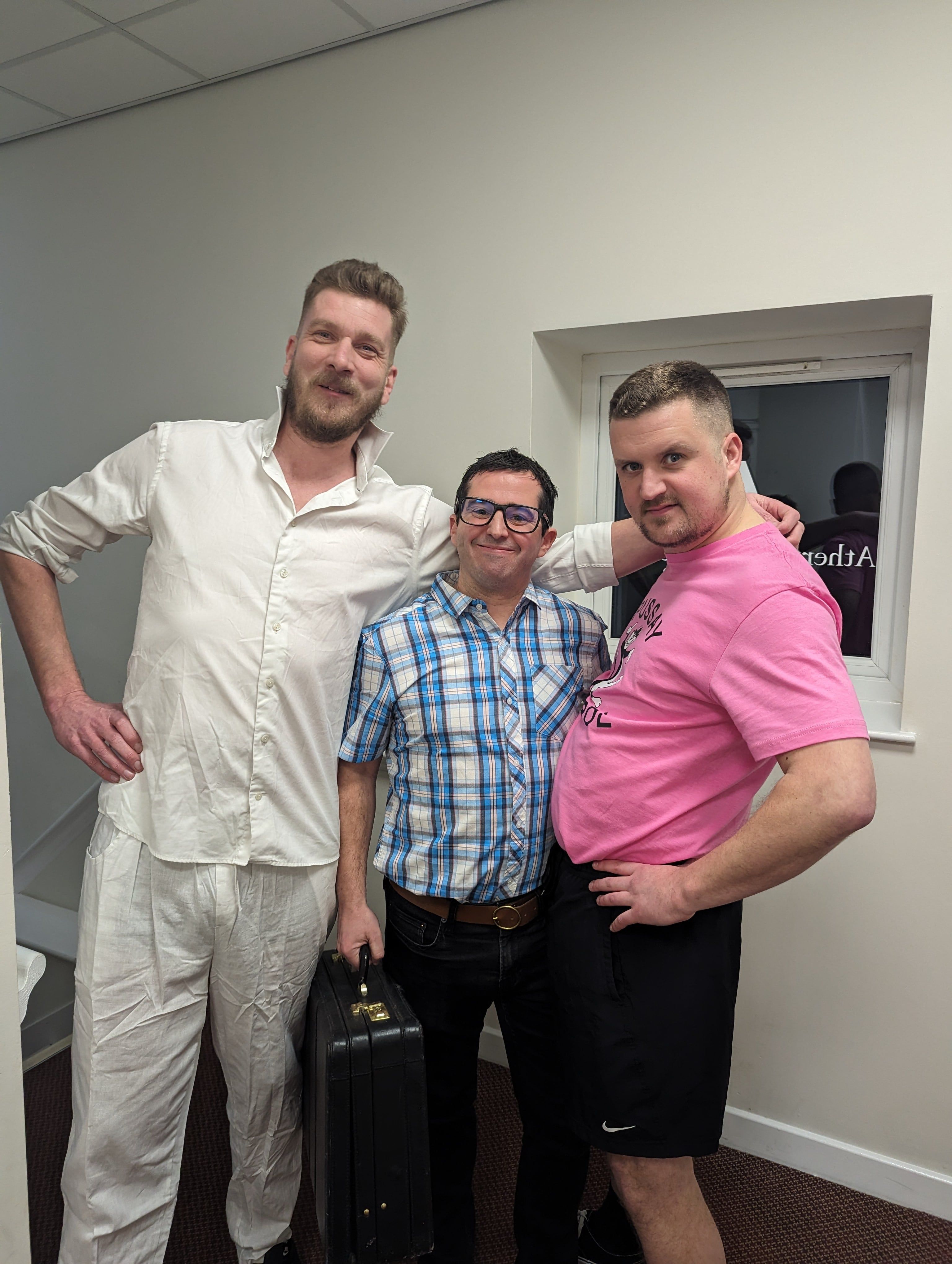 3 men in fancy dress posing and smiling