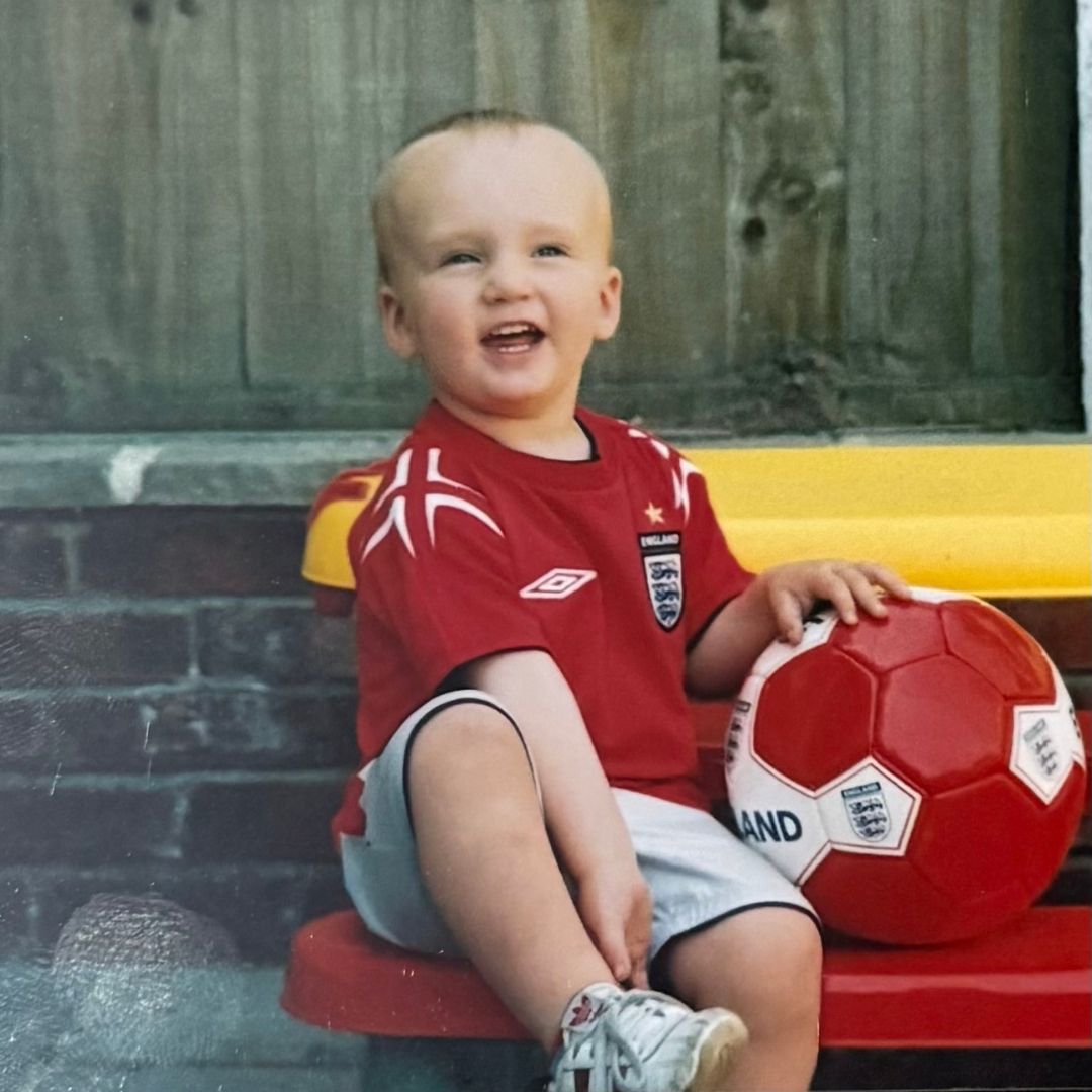 A young recruiter as baby in an England football kit with a ball.