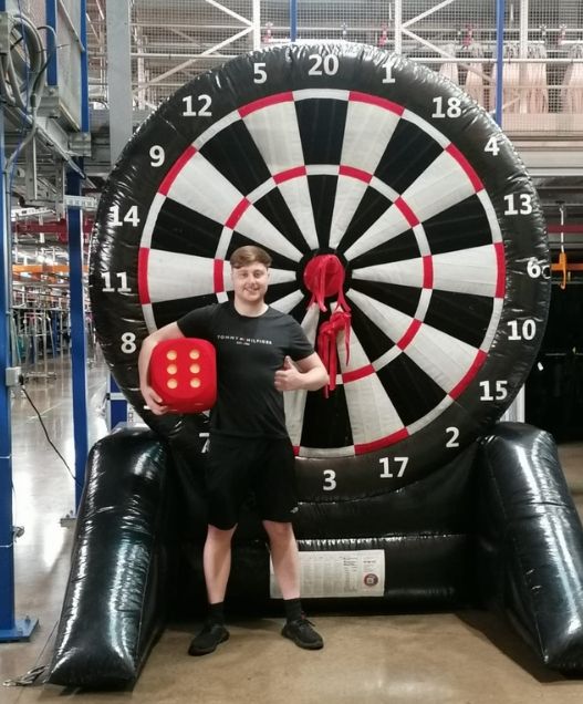 Man in front of dart board