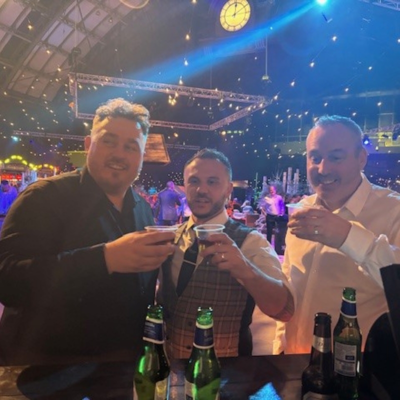 Three male recruiters smiling with drinks.