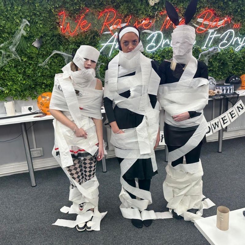 Recruiters dressed for Halloween, wrapped in toilet roll