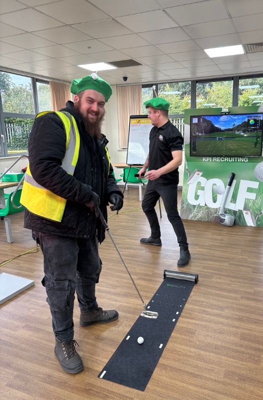 Smiling man on virtual golf holding a putter